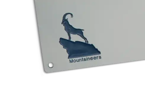 Filigrane, blau ausgelegte CNC-Gravur eines Steinbocks auf einem Felsen.