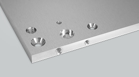 Front panel with different countersunk and tapped holes